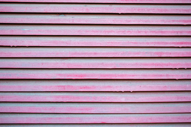 Pink blinds texture background. Selective focus. Shallow depth of field.