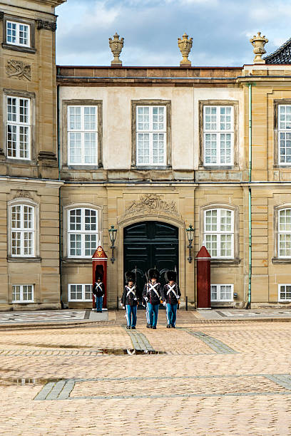 Copenhagen, Denmark -  June 2 2025: Vertical shot of Royal guards performing at Amalienborg Palace Copenhagen
