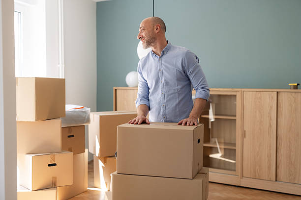istock A man is organizing cardboard boxes in a room during relocation 2225447865