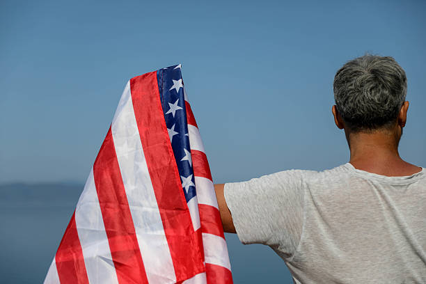 istock Senior Man With USA Flag On Coastline 2225449528
