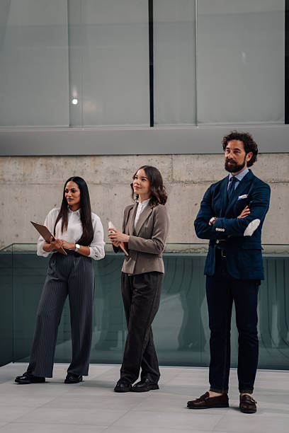 istock Business team standing in modern office lobby 2225451440