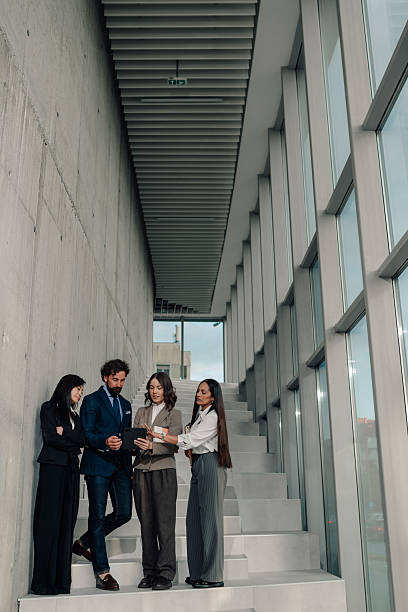 istock Business team discussing strategy on stairs in modern office 2225451458