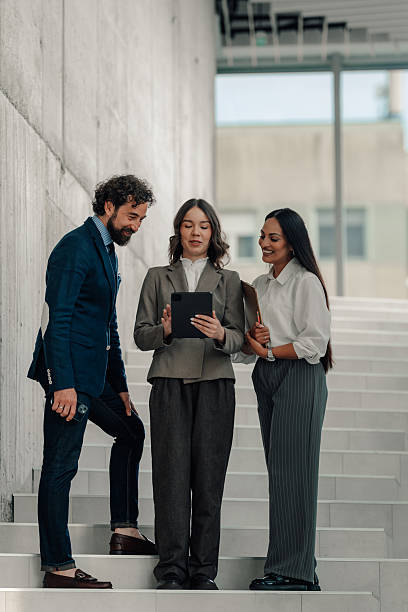 istock Businesspeople collaborating on a digital tablet on stairs 2225451460