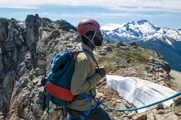 istock View down rope to climber being belayed on mountain top 2225454391