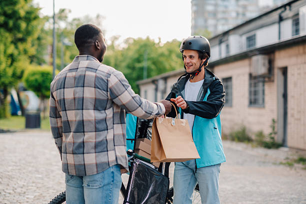 istock Courier delivering food order to customer using bicycle 2225454645