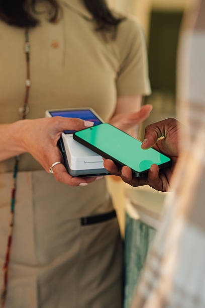 istock Customer paying with smartphone at pos terminal in store 2225456306