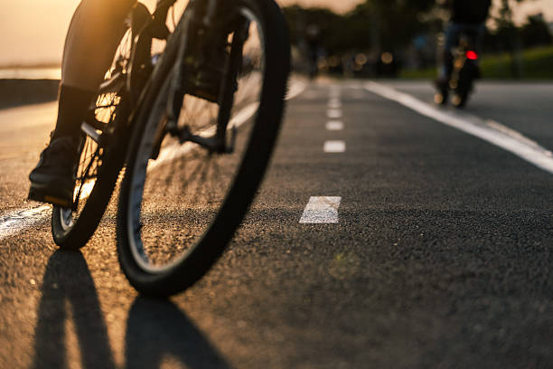istock Unrecognizable cyclist is riding bicycle at sunset. 2225462615