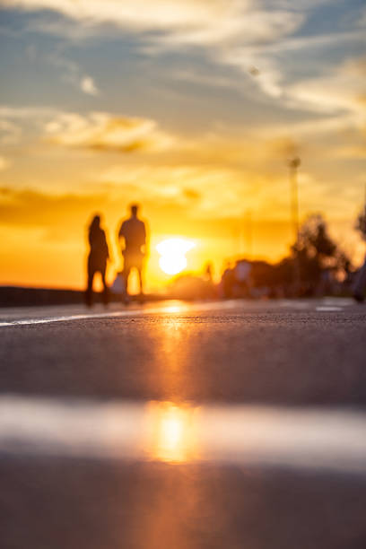 Unrecognizable young couple silhouette in public park at sunset.\nIstanbul - Turkey.