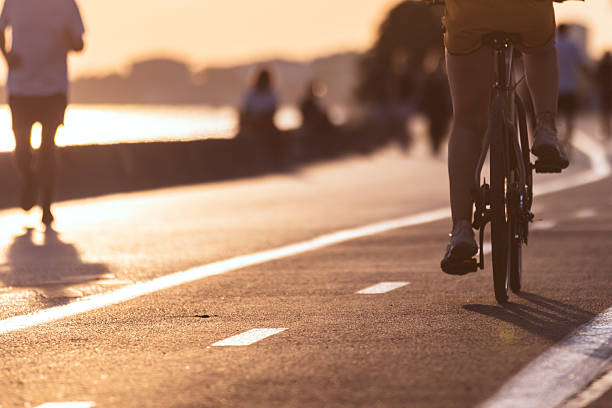istock Unrecognizable cyclist is riding bicycle at sunset. 2225462991