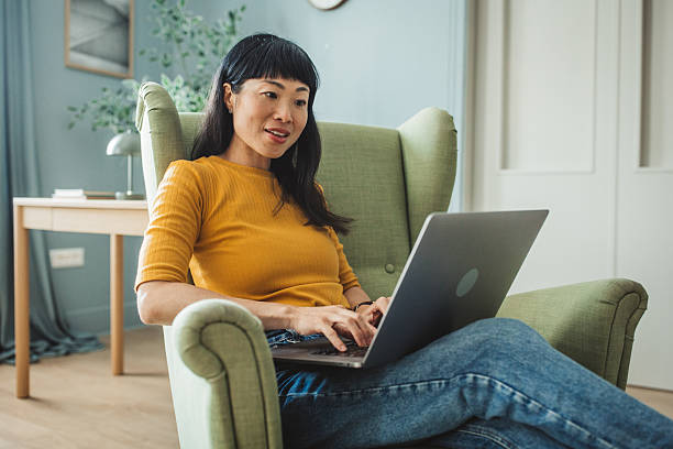 istock Japanese woman using laptop at home 2225465778