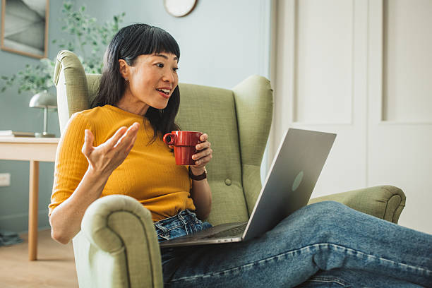 istock Japanese woman using laptop at home 2225465790