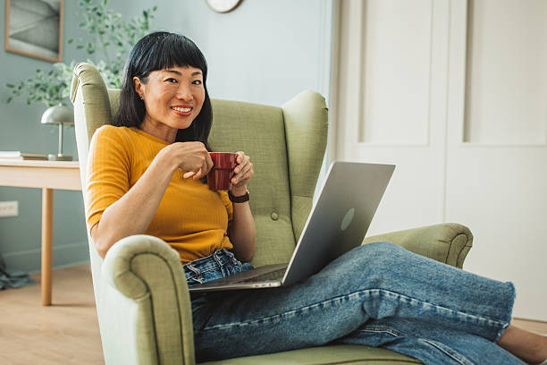 istock Japanese woman using laptop at home 2225465795