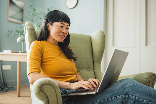 istock Japanese woman using laptop at home 2225465796