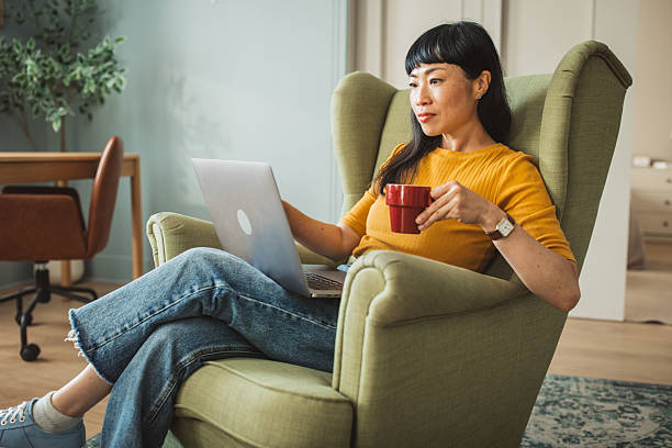istock Japanese woman using laptop at home 2225465804