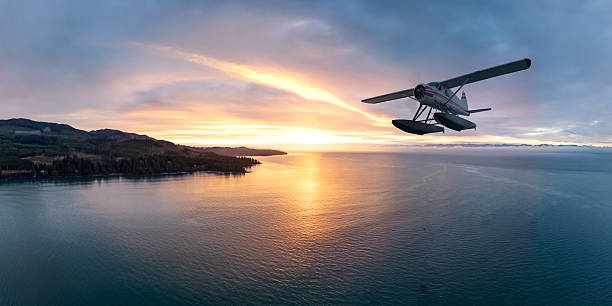 A seaplane glides over a tranquil ocean at sunset in BC, Canada. This 3D rendering captures the serenity and adventure of flight along the stunning coastal landscape.
