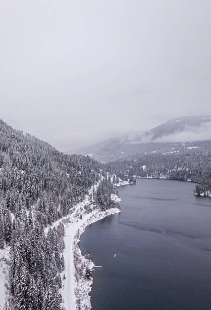 istock Serene Snowy Lakeside with Forested Hills in British Columbia, Canada 2225469570