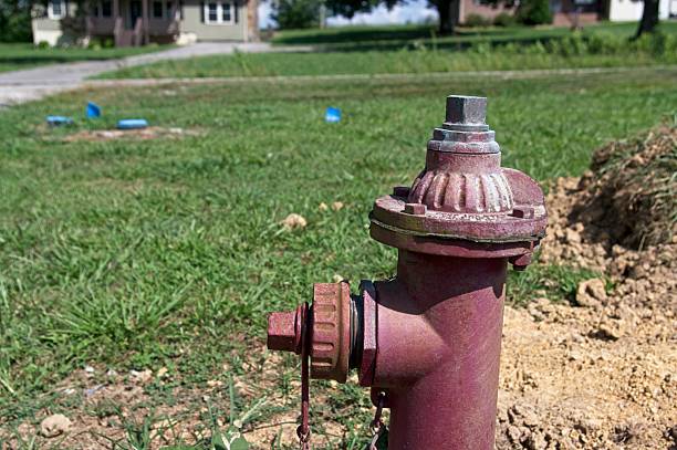 Small water valve with house in background