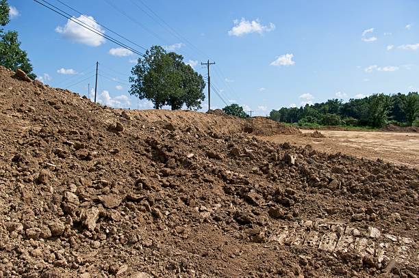 Freshly excavated pile of dirt in a rural setting