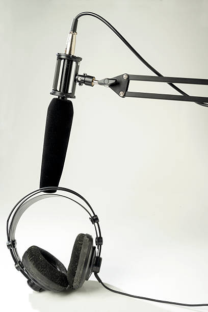 istock Studio microphone for podcasting or streaming on a boom arm with headphones on a white background 2225471533