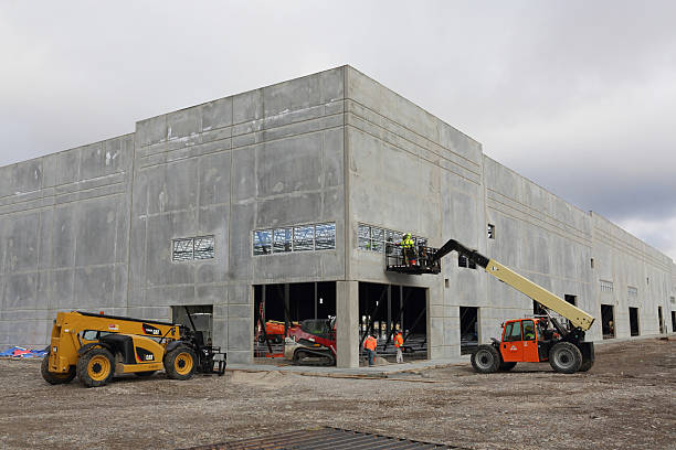 Idaho Falls, Idaho, USA - Oct. 25, 2022: Building work on the exterior of a modern tilt up concrete constructed distribution warehouse.