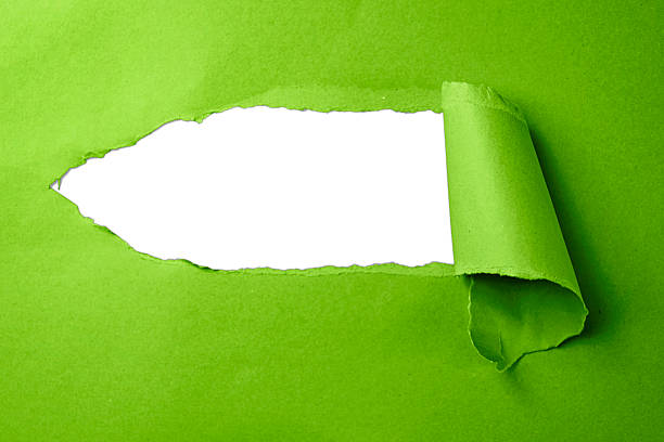 Ripped torn yellow paper piece on white background, paper tear cut out design element clipping path