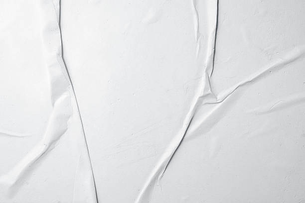 istock White crumpled paper texture abstract background. Creased and wrinkled paper surface. Copy space 2225474555