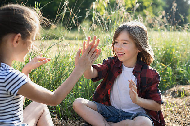 istock Happy friends playing hand-clapping game in a hot summer day 2225481092