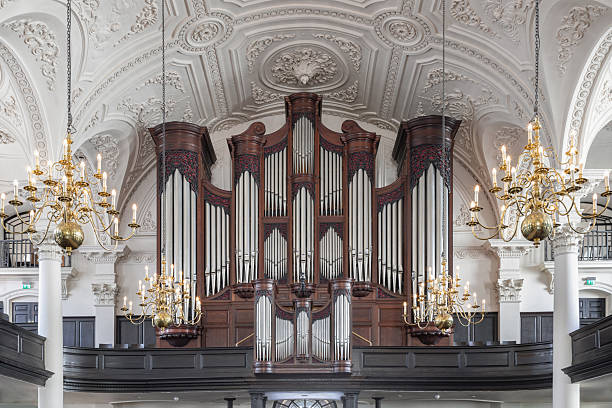 London, UK - Jul 12, 2025 - A magnificent Georgian architecture of St Martin-in-the-Fields including with arched ceilings, Corinthian columns and The large organ prominently. use it as your Wallpaper, Poster and Space for text, Selective focus.