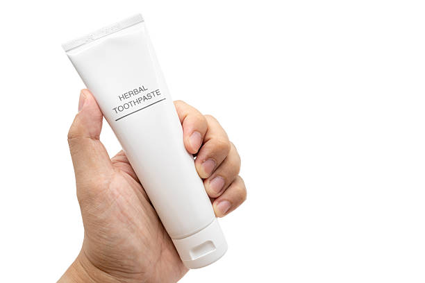 istock Hand Holding Toothpaste Tube isolated on White Background with Copy Space.  Clipping path. 2225490493