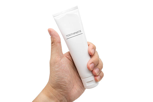 istock Hand Holding Toothpaste Tube isolated on White Background with Copy Space.  Clipping path. 2225490496