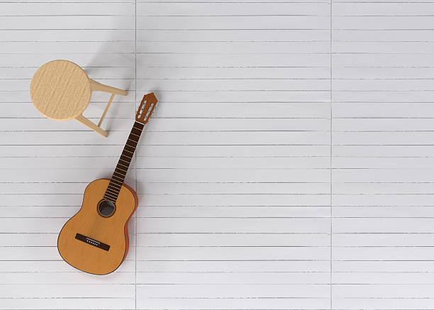 classic wooden guitar standing near a white brick wall in soft natural light