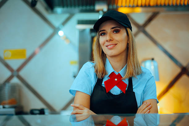 istock Happy Fast-food Worker Smiling from Over the Counter 2225490866