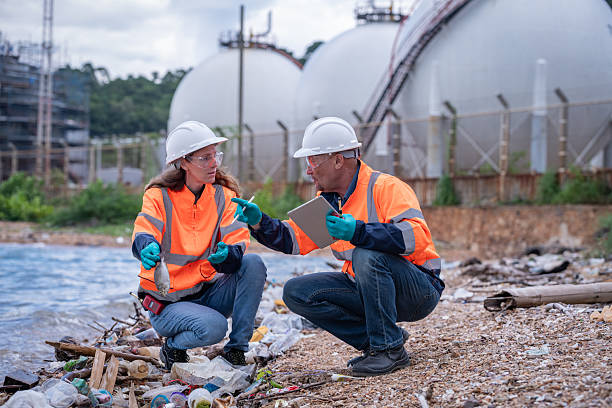 istock Environmental engineer or workers examining waste water along a  large industrial waste water or pollution monitoring and maintenance to ensure systems operate effective environmental regulations. 2225493936