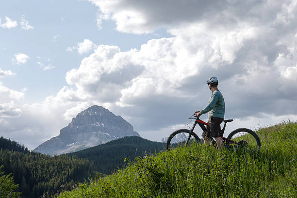 istock Young man mountain bikes along flow track 2225494302