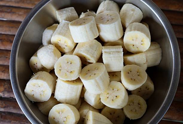 istock Peeling and cutting Banana - fruit preparation. 2225498137