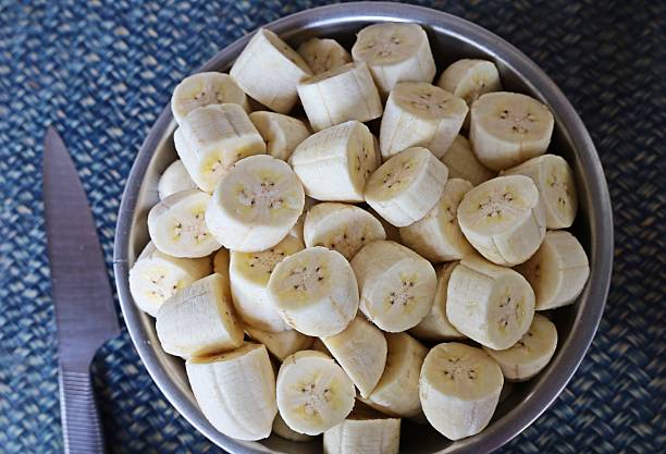 istock Peeling and cutting Banana - fruit preparation. 2225498315