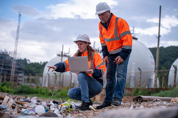 istock Environmental engineer or workers examining waste water along a  large industrial waste water or pollution monitoring and maintenance to ensure systems operate effective environmental regulations. 2225498483