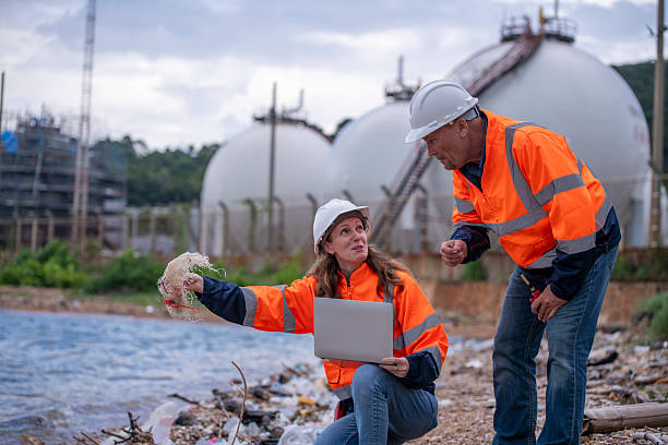 istock Environmental engineer or workers examining waste water along a  large industrial waste water or pollution monitoring and maintenance to ensure systems operate effective environmental regulations. 2225498484