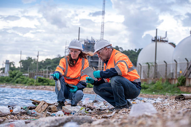 istock Environmental engineer or workers examining waste water along a  large industrial waste water or pollution monitoring and maintenance to ensure systems operate effective environmental regulations. 2225498509