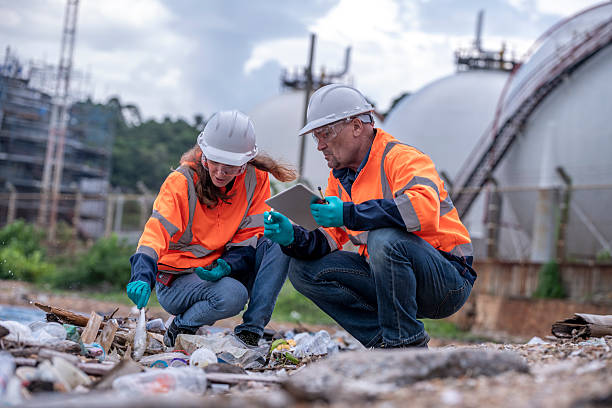 istock Environmental engineer or workers examining waste water along a  large industrial waste water or pollution monitoring and maintenance to ensure systems operate effective environmental regulations. 2225498543