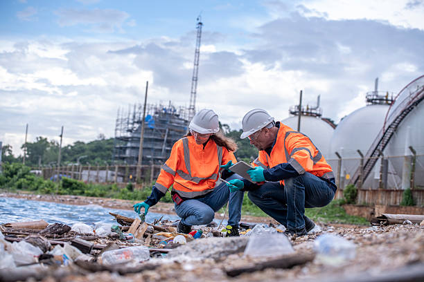 istock Environmental engineer or workers examining waste water along a  large industrial waste water or pollution monitoring and maintenance to ensure systems operate effective environmental regulations. 2225498544