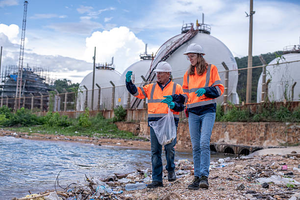 istock Environmental engineer or workers examining waste water along a  large industrial waste water or pollution monitoring and maintenance to ensure systems operate effective environmental regulations. 2225498593