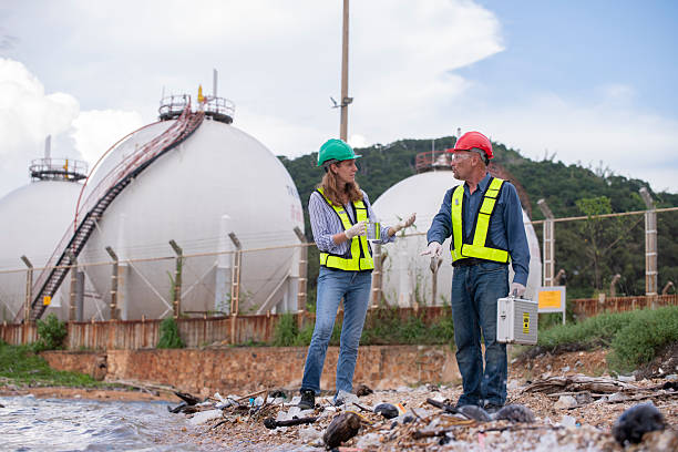 istock Environmental engineer or workers examining waste water along a  large industrial waste water or pollution monitoring and maintenance to ensure systems operate effective environmental regulations. 2225498779
