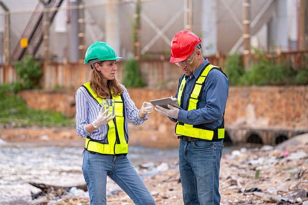 istock Environmental engineer or workers examining waste water along a  large industrial waste water or pollution monitoring and maintenance to ensure systems operate effective environmental regulations. 2225498835