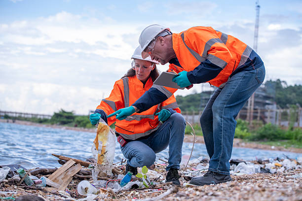istock Environmental engineer or workers examining waste water along a  large industrial waste water or pollution monitoring and maintenance to ensure systems operate effective environmental regulations. 2225498921