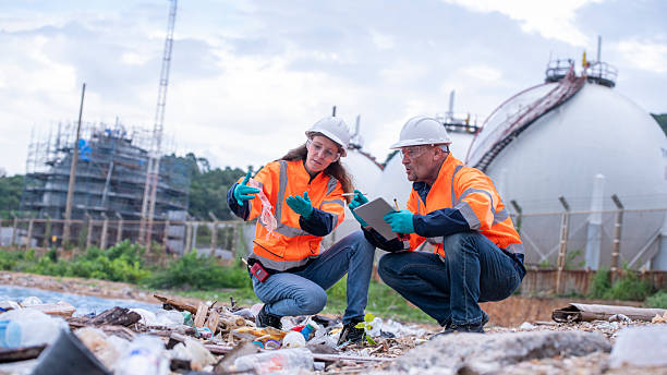 istock Environmental engineer or workers examining waste water along a  large industrial waste water or pollution monitoring and maintenance to ensure systems operate effective environmental regulations. 2225498939