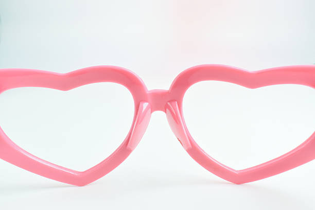 istock pink heart shape of glasses on white background 2225502144