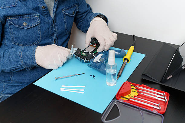 istock Technician repairing joystick with soldering iron and tools on table 2225502511