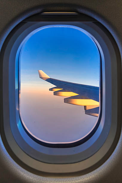 istock Airplane window frame Aircraft wing skyline Travel aboard 2225503020