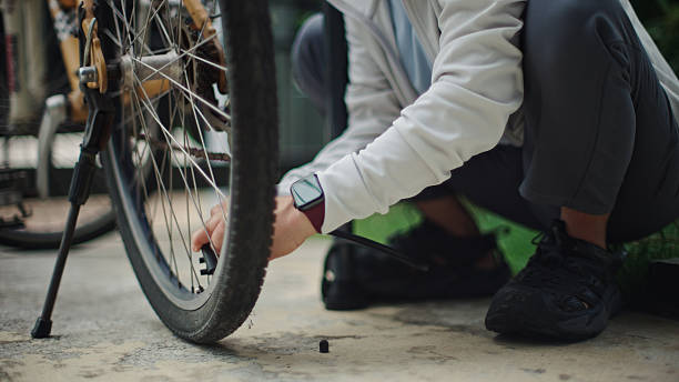 istock Mature woman inflating a bicycle tire. 2225507986